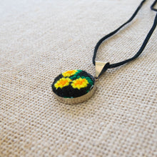 Pendant with Hand Embroidered Yellow Flowers.